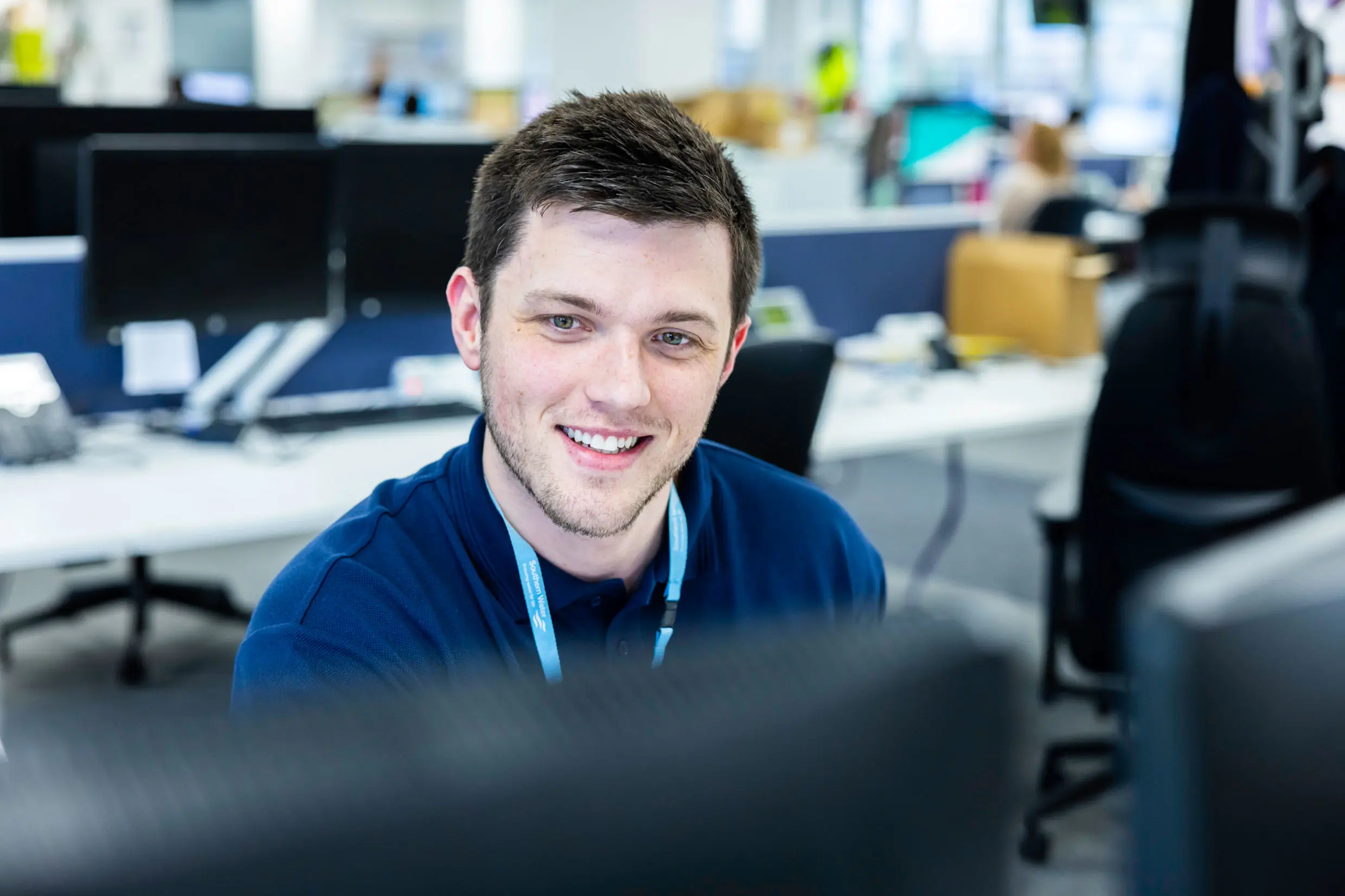 Southern Water team member smiling at computer