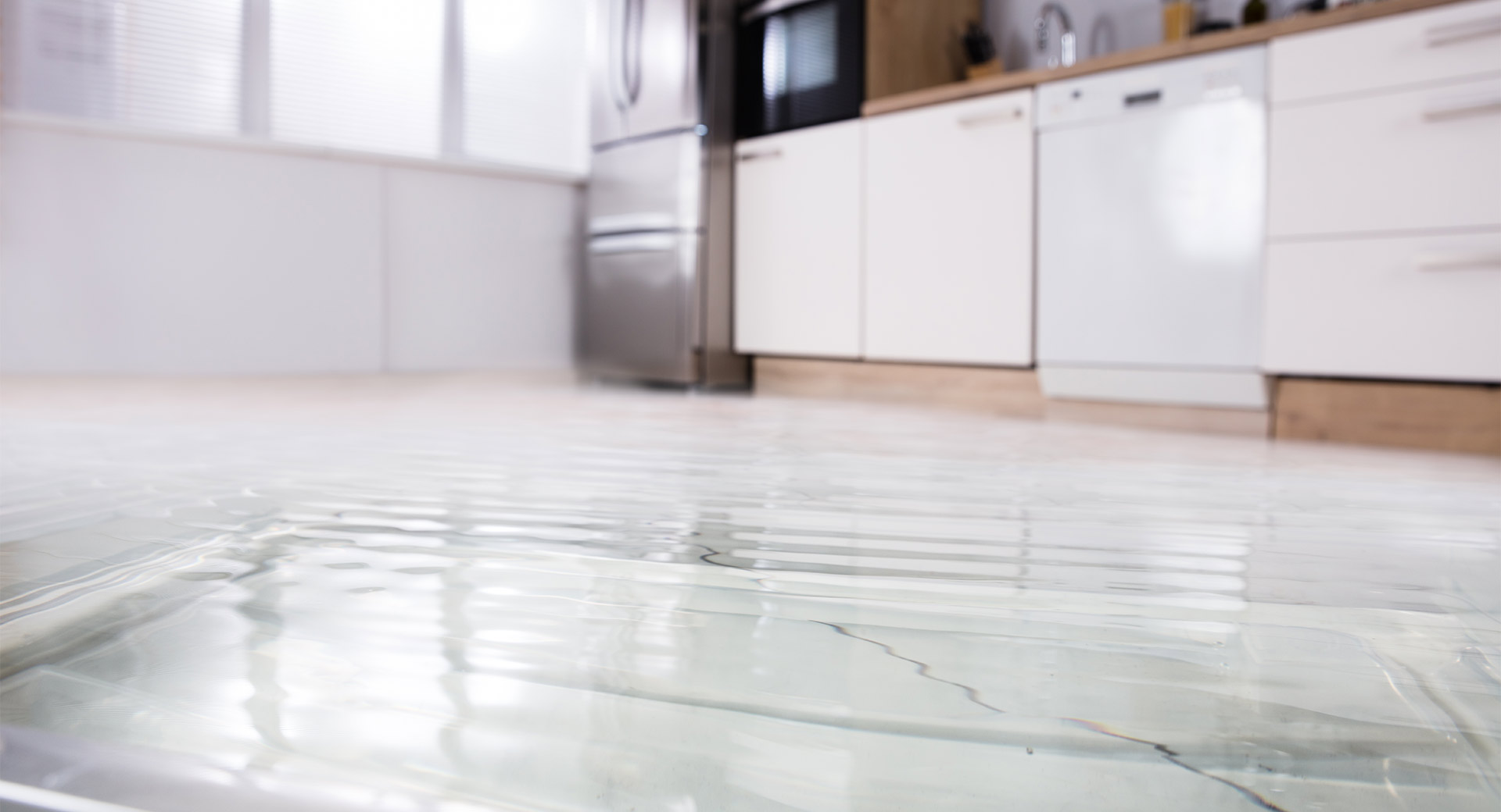 A kitchen with a flooded floor